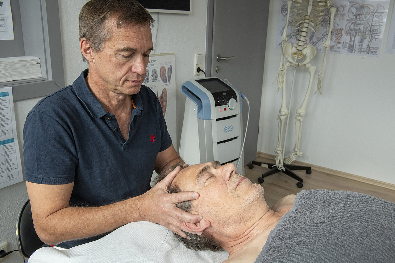 Patient bekommt Kopfmassage vom Arzt